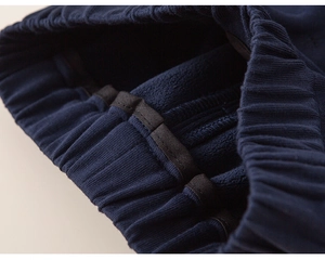 Detail of high-elastic ribbed waistband and warm fleece lining on toddler navy pants