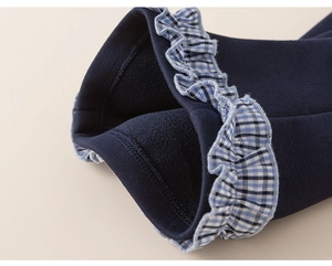 Close-up of children's thermal pants featuring soft fleece lining and ruffled plaid cuffs