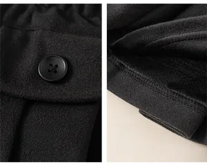 Detailed view of kids wool skirt showing black button decor and thick fleece lining
