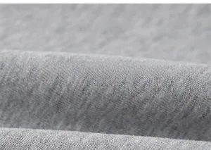 Detailed macro view of soft heather grey knit fabric texture for boys sweatshirt