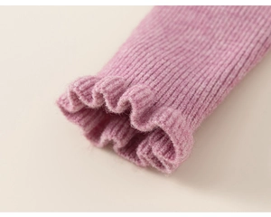 Detail of pink-purple ribbed knit sleeve featuring delicate ruffle cuffs on a girl's dress