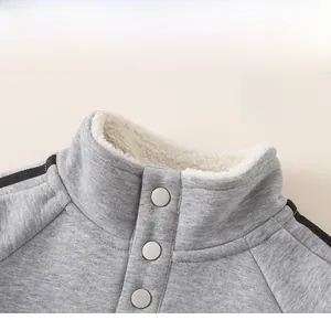 Close-up of boys gray sweatshirt collar with warm fleece lining and buttons