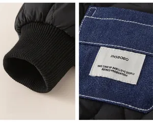 Detail view of winter jacket featuring windproof ribbed cuffs and denim patchwork pocket