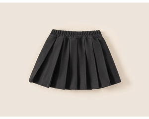 Detail of children's black pleated skirt featuring elastic waistband and knit texture