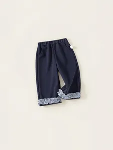 Navy blue girls trousers with plaid ruffle cuffs and comfortable elastic waistband
