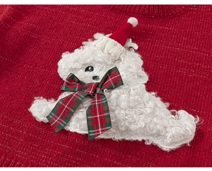 Close-up of red knitted sweater featuring a 3D plush dog with a Christmas hat and bow