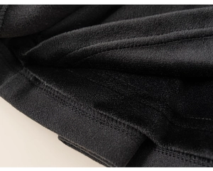 Detailed macro view of soft black fleece lining and durable double stitching on kids skirt
