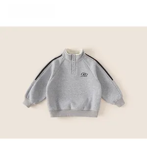 Detail of gray boys' winter sweatshirt featuring half-zip collar and warm fleece lining