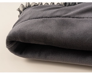Detail of dark grey velvet fabric with black mesh lace trim for girls' winter dresses