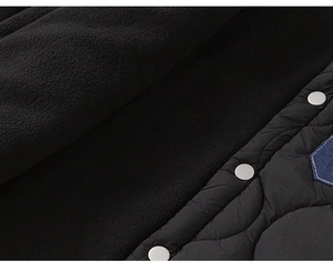 Detail of boys winter jacket showing warm black fleece lining and quilted outer fabric