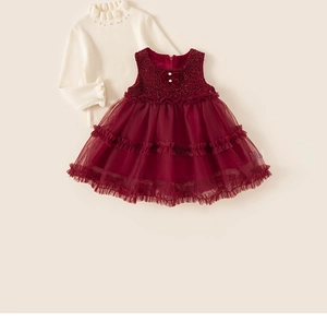 Detail of baby girl two-piece dress with pearl collar knitwear and red sequin tulle skirt