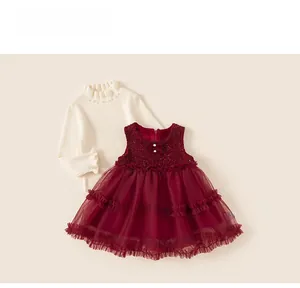Detail of baby girl winter dress set with pearl knit sweater and wine red tulle skirt