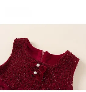 Detail of red tweed dress with velvet bows and pearls on the neckline for girls