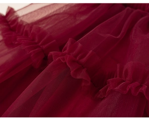 Close-up of wine red multi-layered mesh tulle fabric with elegant ruffle details