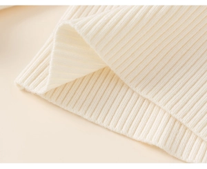 Macro shot of high-quality white ribbed knit fabric texture on kids winter dress outfit