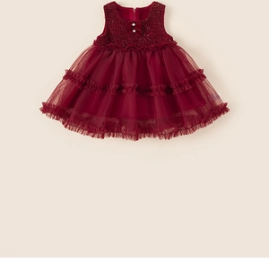 Detail of red sleeveless tutu dress showing sequined bodice, pearl bow, and layered mesh