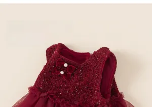 Detail of red sleeveless tutu dress with sequined tweed and velvet bow accents