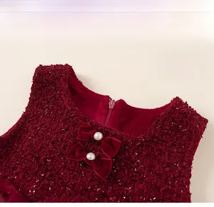 Detailed macro view of burgundy tweed fabric with silver sequins and velvet bow accents