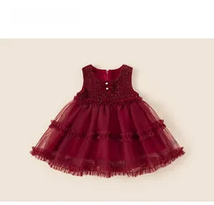 Detail of burgundy sleeveless tulle dress with sequined bodice and pearl bow accent