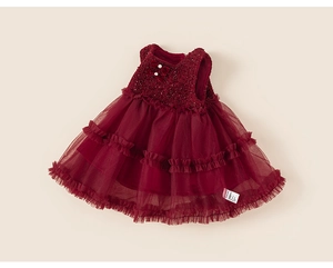 Macro shot of burgundy tulle layers and sequin fabric with velvet bows on a dress