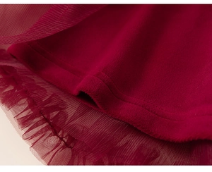 Detail of red tutu dress showing thick fleece lining and delicate mesh fabric texture