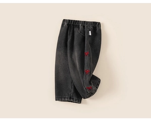 Detail of red bow embroidery on charcoal wash girls' denim pants with elastic waist