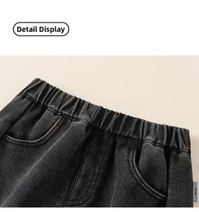 Close-up detail of children's dark wash denim jeans with elastic waistband and pockets