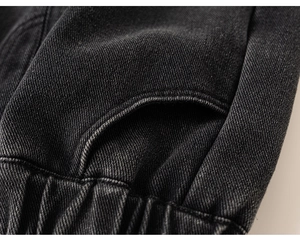 Detail shot of girls dark grey denim jeans showing twill texture and reinforced stitching
