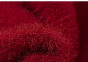 Close-up of fluffy red knit sweater fabric showing soft plush faux mink hair texture