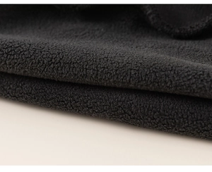 Gros plan sur la texture du tissu polaire noir doux pour le sweat-shirt chaud pour enfant