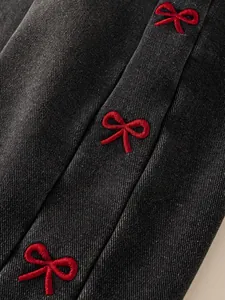 Fashionable dark grey denim girls jeans with detailed red bow embroidery and twill texture
