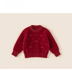 Detail of red plush kids sweater featuring white pearl accents and sweet bow tie decor