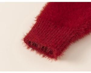 Detailed macro view of plush red knit sleeve cuffs showing warm mohair texture