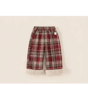 Close-up of children's plaid pants with elastic waist and white faux shearling cuffs