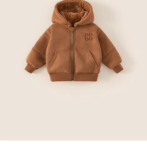 Detail of boys brown winter jacket with thick sherpa lining and embossed BOBO lettering