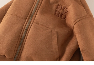 Close-up of brown suede jacket with BOBO embroidery and premium metal zipper detail