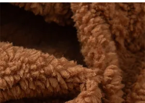 Detailed macro view showing the soft texture of brown lamb wool fabric for kids jacket
