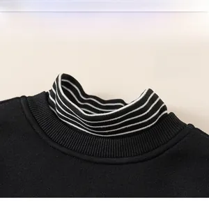 Detail view of boys' striped stand collar and ribbed neckline of faux two-piece sweatshirt