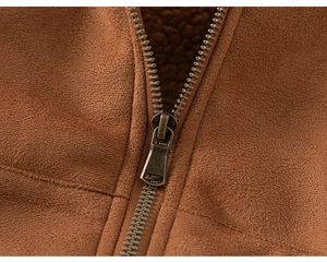 Detailed close-up of brown suede jacket with warm sherpa lining and metal zipper
