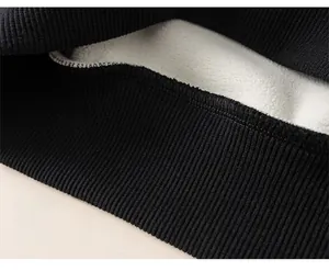Close-up of black ribbed hem and thick white fleece lining on boys striped sweatshirt