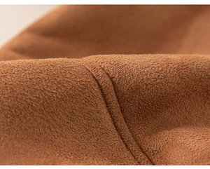 Macro shot of premium brown faux suede fabric with precise stitching details for kids' coats