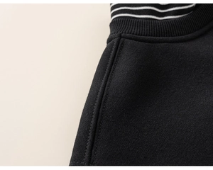 Detailed view of the crew neck stitching and striped inner lining of this boys sweatshirt