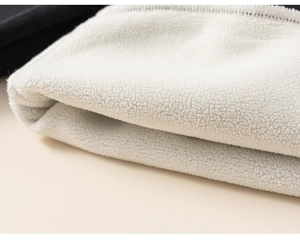 Close-up of thick white fleece lining texture on children striped pullover sweatshirt