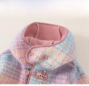 Detail of girls cute plush rainbow hooded coat with embroidery and button closure