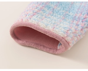 Detail of soft blue and pink plaid sherpa fabric with warm pink lining and neat piping