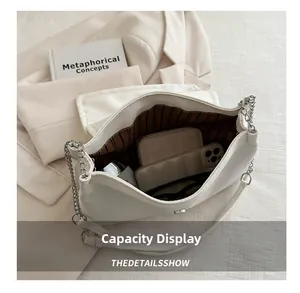 Interior view of white crossbody bag showing large capacity for phone and wallet