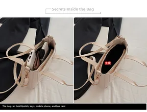 Detail of beige crescent bag main compartment showing large storage space for essentials