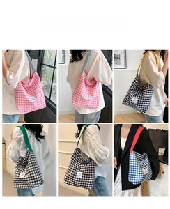 Vue détaillée des sacs fourre-tout à carreaux multicolores avec larges bandoulières