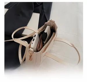 Interior view of off-white crescent bag showing spacious compartments and items