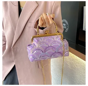 Detailed macro of lavender lace handbag with pearl clasp and golden metal handle